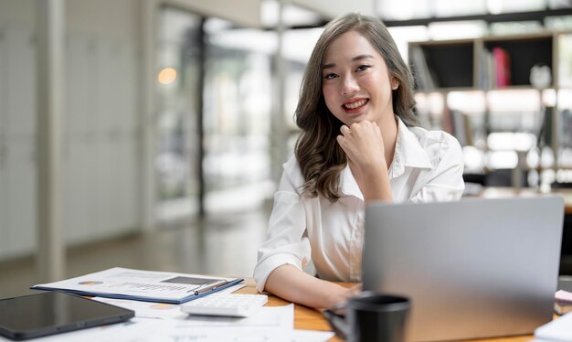 image-young-beautiful-joyful-woman-smiling-while-working-with-laptop-office_44344-4160
